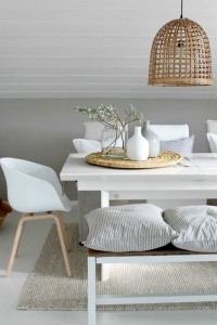 Casual-and-modern-dining-room-cushions-on-a-bench-white-dining-chairs-mix-in-natural-elements